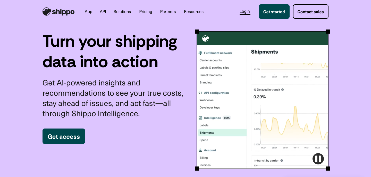 A frame of the product-tour video playing on Shippo's Intelligence page, showing the app's left navigation — Fulfillment network (Carrier accounts, Labels & packing slips, Parcel templates, Branding), API configuration (Webhooks, Developer keys), Intelligence BETA (Labels, Shipments highlighted, Spend) and Account (Billing, Invoices) — beside a Shipments view holding a line chart dated 08/24 to 09/28, a “% Delayed in-transit” panel reading 0.39% over a spiky area chart, and the top of an “In-transit by carrier” breakdown; the video's pause control sits over the lower right of the panel